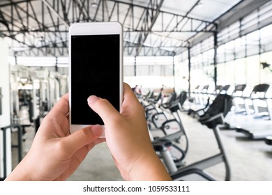 Hands Using Smartphone In Fitness Sport Gym With Mockup Mobile For Present.