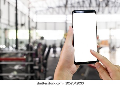 Hands Using Smartphone In Fitness Sport Gym With Mockup Mobile For Present.