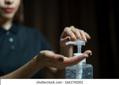 hands using wash hand sanitizer gel pump dispenser. Clear sanitizer in pump bottle, for killing germs, bacteria and virus. - Shutterstock ID 1661743201