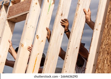 Hands of volunteers raising a wall for a Habitat for Humanity home - Shutterstock ID 1664636290