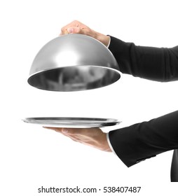 Hands of waiter holding metal tray with cover on white background