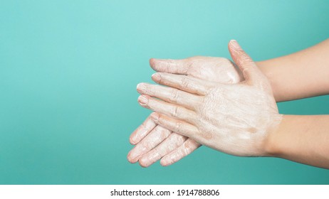 Hands Washing Gesture With Foaming Hand Soap On Green And Tiffany Blue  Background.