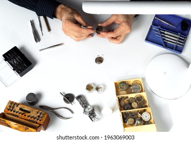 The hands of a watchmaker repairing a mechanical watch. - Powered by Shutterstock