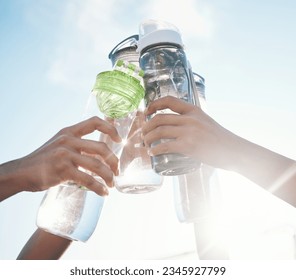 Hands, water bottle and toast to fitness together after workout, exercise or training outdoor with team of players. Sport, goals and cheers with group and liquid for hydration, celebration and unity - Powered by Shutterstock