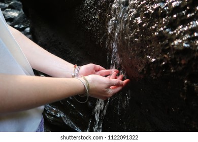 Hands in waterfall 