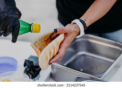 Hands Wear Black Vinyl Gloves Making Gyros Shawarma For Take Away. Fast Food Sandwich With Vegetables And Meat. Close Up Image With Selective Focus