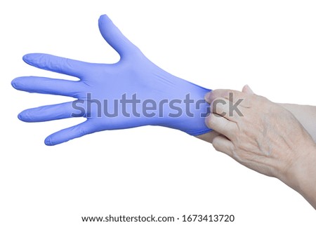 Hands wearing a blue latex glove on white background