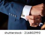 Hands of wedding groom getting ready in suit