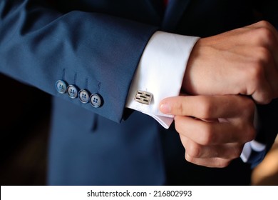 Hands of wedding groom getting ready in suit - Powered by Shutterstock