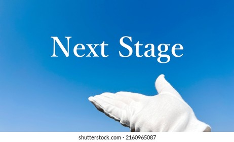 Hands With White Gloves And The Letters Next Stage In Blue Sky Background