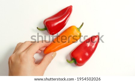 Hands who hold paprika against a white background