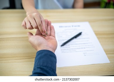 The hands of wife and husband with the order of divorce, dissolution, cancellation of marriage, legal separation documents, divorce filings or pre-marital agreements prepared by a lawyer.