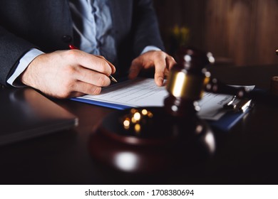 Hands of wife, husband signing decree of divorce, dissolution, canceling marriage, legal separation documents, filing divorce papers or premarital agreement prepared by lawyer. Wedding ring - Shutterstock ID 1708380694