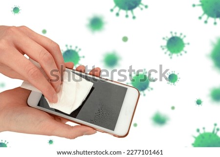 Hands wiping the phone screen with an antibacterial wipe. Close-up. Mobile phone care and cleaning. Women's hands wipe the screen with a cloth