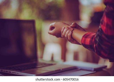 Hands of woman with carpal tunnel syndrome over computer keyboar