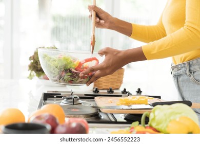 Hands of woman cooking salad in kitchen room at home - Powered by Shutterstock