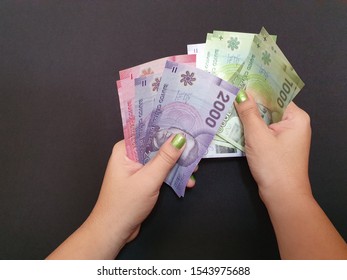 Hands Of A Woman Counting Chilean Money