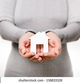 Hands Of Woman Holding Paper House