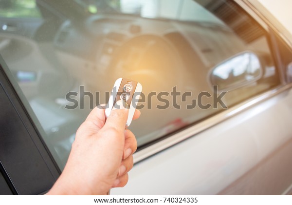 Hands woman holding push remote control\
car for test system, transportation safety insurance concept.\
Remote control is component of electronic device used to operate\
device wirelessly from\
distance.