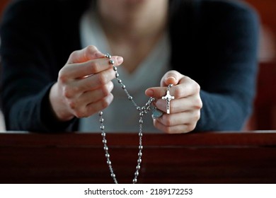 Hands of a woman holding a rosary or crucifix while praying, Christian daily devotional of a worshiper of God the Savior.  Basilica of Our Lady of La Vang.  Pilgrimage.  La Vang. Vietnam.  - Shutterstock ID 2189172253