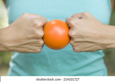 Hands Of A Woman Holding A Stress Ball 