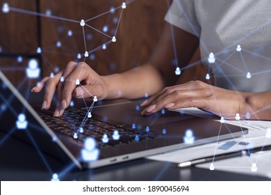 Hands of woman hr specialist is typing the keyboard in the internet to find the best candidates to create international network in recruitment process. Casual wear. Social media hologram icons.