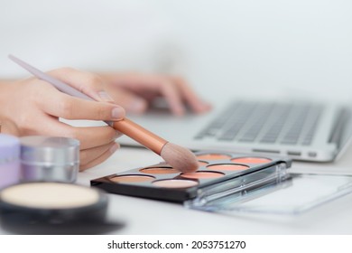 Hands Of Woman With Learning Makeup With Brush On Cheek On Laptop Computer With Tutorial Course Online, Female Teaching And Explain Make Up With Makeup Palette And Cosmetic On Streaming Social Media.