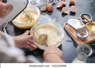 Hands Of Woman Mixing Liquid Dough For The Cake With Whisk, View From Above