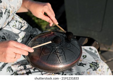 Hands Of Woman Musician Playing Steel Tongue Drum,music And Gluckophone Instrument.