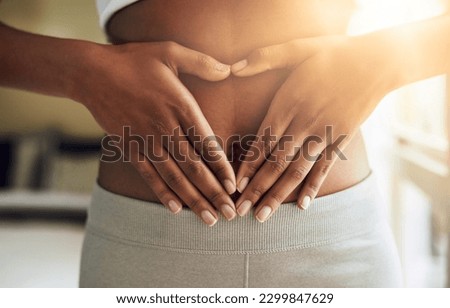 Hands of woman on stomach, diet and fitness for gut health and lipo wellness for body positivity. Gym, healthcare and tummy tuck, girl model with heart hand sign on abdomen for muscle exercise goals.