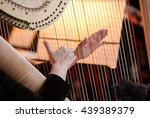 Hands of the woman playing a harp. Symphonic orchestra. Harpist close up.