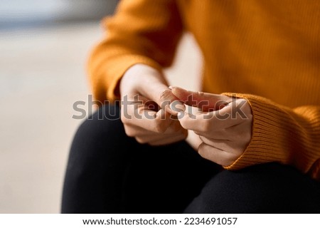 Hands of a woman playing with nails in stress