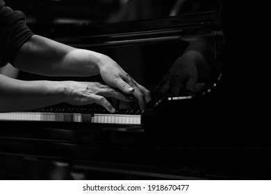 Hands Of A Woman Playing The Piano Close Up In Black And White