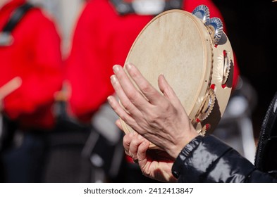 hands of a woman playing a tambourine - Powered by Shutterstock