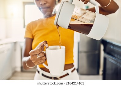 Hands of woman pouring coffee into a mug, standing inside a kitchen at home. French press with homemade, fresh, and delicious warm drink to start the morning or day with a brewed caffeine beverage - Powered by Shutterstock