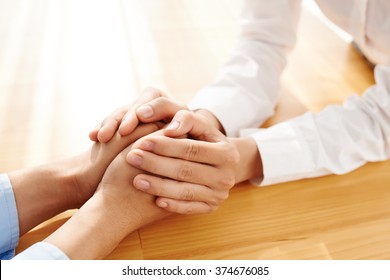 Hands of woman reassuring her colleague