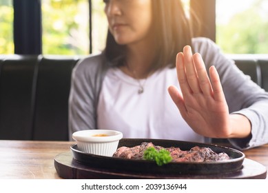 Hands woman refusing beef steak in restaurant,No meal,Vegetarian and vegan concept