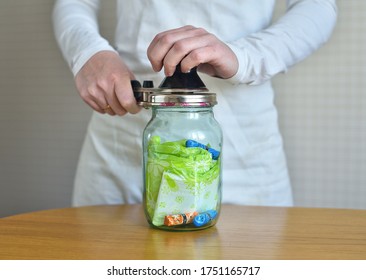 Hands Woman Rolls A Jar Of Sanitary Pads