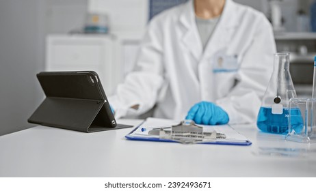 Hands of woman scientist using touchpad at laboratory - Powered by Shutterstock