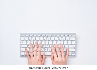 Hands of a woman typing on a keyboard
