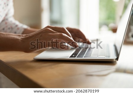 Hands of woman typing on keyboard, using app on laptop. Freelance employee working from home. Author, writer, student, blogger writing essay or article, chatting online, doing research. Close up