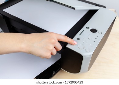 Hands of a woman using a copying machine close up