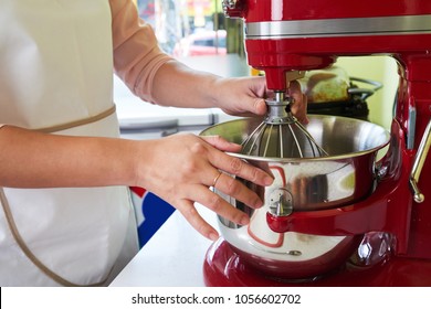 Hands Of Woman Using Electric Mixer To Make The Dough