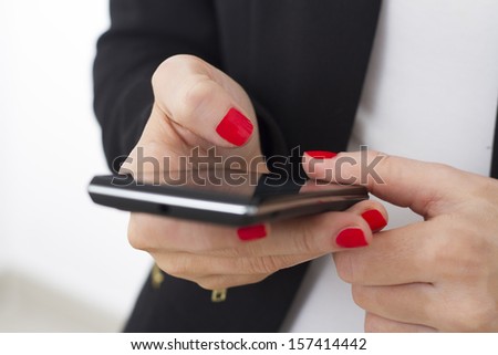 Hands of a woman using a smartphone.