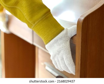 Hands With Work Gloves Carrying A Study Desk