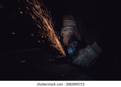 Hands Of A Worker With A Circular Saw Cutting A Metal Plate Selective Focus