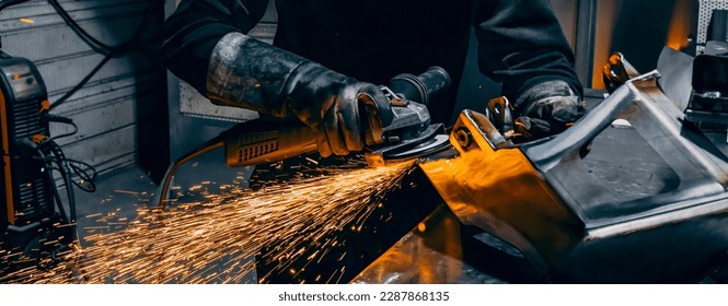 Hands of worker grinding a piece of metal, France