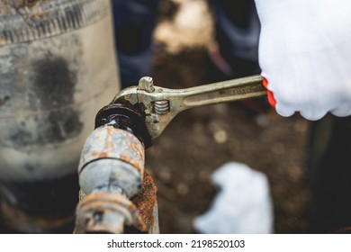 Hands Of Worker Repairing Car Parts In Auto Scrap.