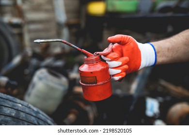 Hands Of Worker Repairing Car Parts In Auto Scrap.Uses Oil For Lubrication.