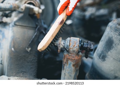 Hands Of Worker Repairing Car Parts In Auto Scrap. 